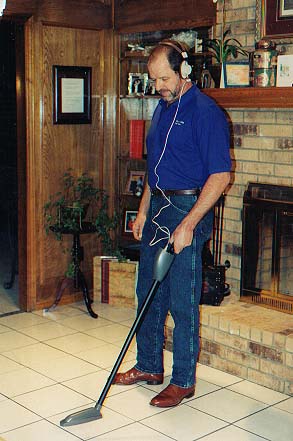 Technician tracing a water line across a tile floor with the Pulsar 2000 Line Tracer